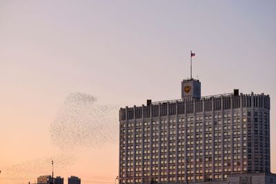 Low angle view of buildings against sky during sunset