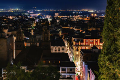 High angle view of illuminated buildings in city at night