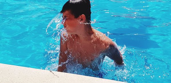 High angle view of boy swimming in pool