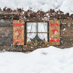 Under a heavy snowfall. walk in the ancient village of sappada. friuli