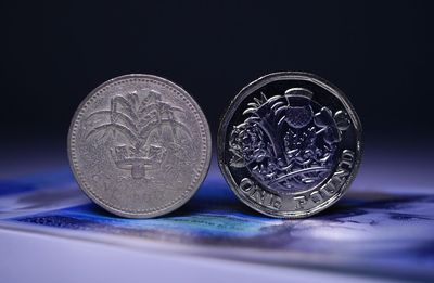 Close-up of coins on table against black background