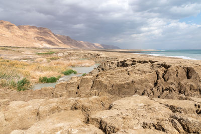 Storm and rain at dead sea coastline. salt crystals at sunset. texture of dead sea. salty seashore