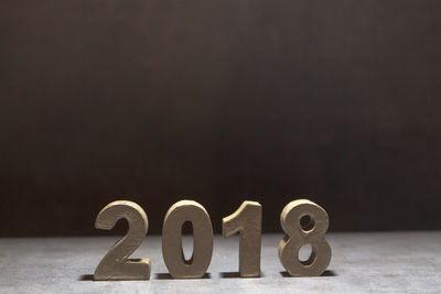 Close-up of 2018 on table against black background
