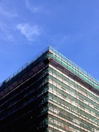 Low angle view of modern building against blue sky