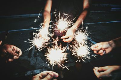 Low angle view of hand holding sparkler