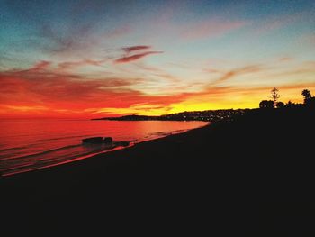 Scenic view of sea against orange sky