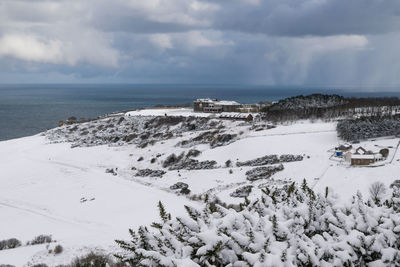 Scenic view of sea against sky during winter