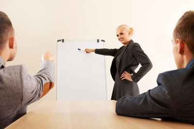 Rear view of people standing at table