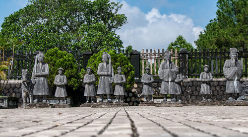 Stone soldiers stand guard in front of the tomb of emperor khai dinh