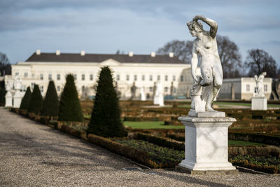 Statue against sky in city