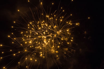 Low angle view of firework display at night