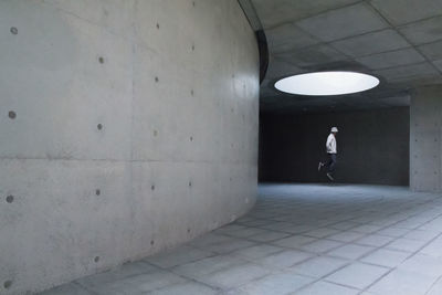 Man walking in illuminated tunnel