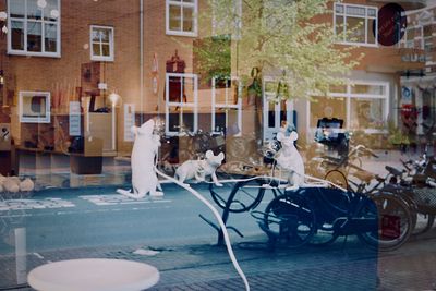 Chairs and tables on street against buildings in city