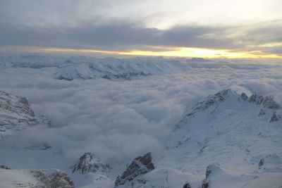 Scenic view of snowcapped mountains against sky during sunset