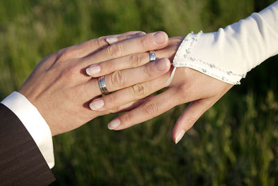 Close-up of couple holding hands