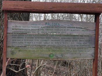 Close-up of sign board on field