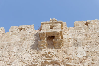 Low angle view of historical building against blue sky