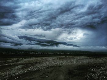 Scenic view of sea against cloudy sky