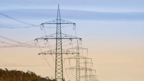 Low angle view of electricity pylon against sky