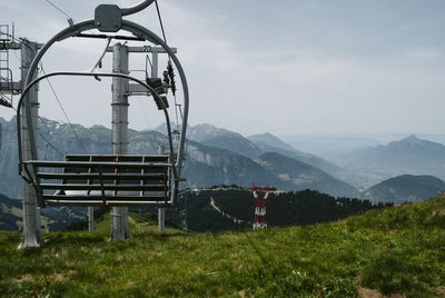 Built structure on field by mountains against sky