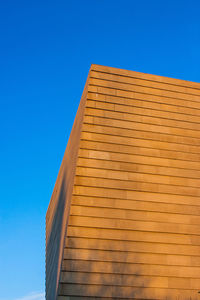 Low angle view of building against clear blue sky