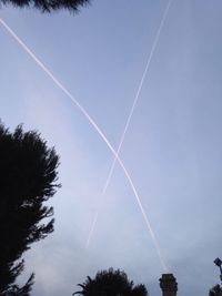 Low angle view of vapor trails in sky