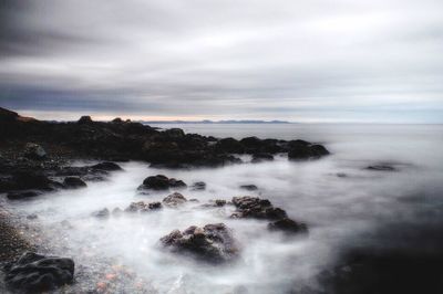 Scenic view of sea against cloudy sky