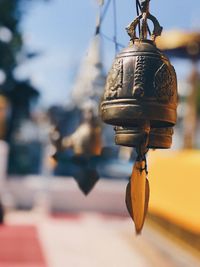 Close-up of electric lamp hanging on metal