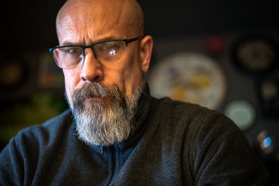 Older man with gray beard looking serious