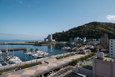 High angle view of harbor by buildings against sky