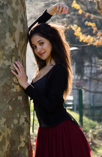 Portrait of beautiful young woman standing outdoors