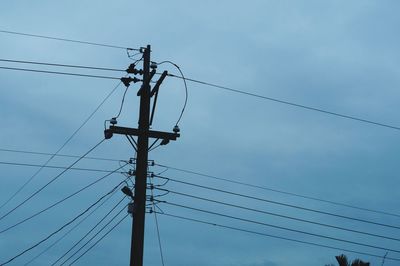 Low angle view of electricity pylon against sky