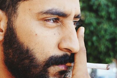 Close-up portrait of young man looking away