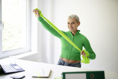 Portrait of young businesswoman standing against white background