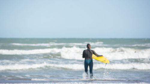 Full length of man on beach against sky