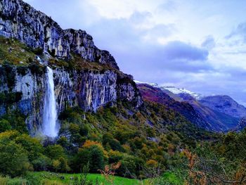 Scenic view of waterfall against sky