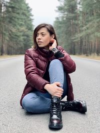 Portrait of woman sitting on the road