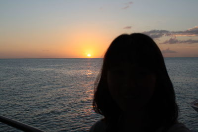 Portrait of silhouette woman against sea during sunset