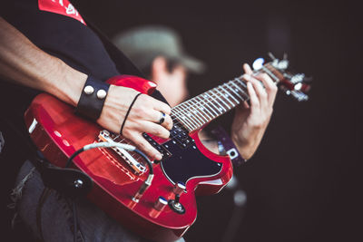 Cropped image of man playing guitar