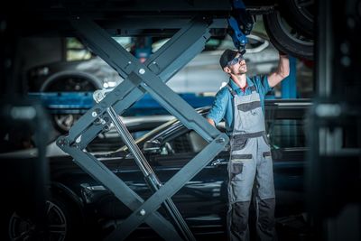 Mechanic repairing car tire in garage