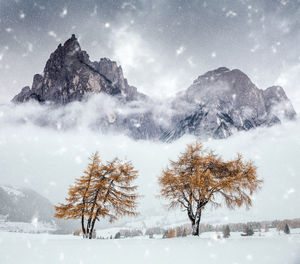 Scenic view of mountains during snowfall