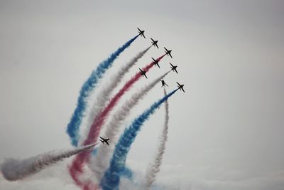 Low angle view of airshow against clear sky