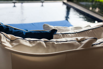 High angle view of cushions on sofa at poolside