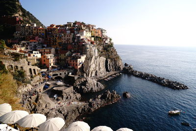 High angle view of buildings by sea against sky