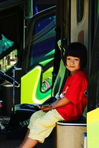 Portrait of boy sitting in bus