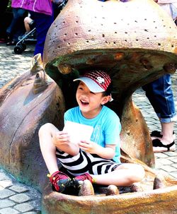 Smiling young couple sitting on water