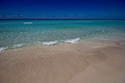 Scenic view of sea against clear blue sky