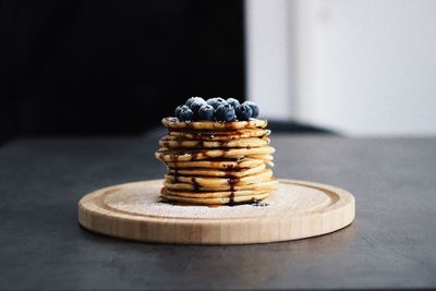 Close-up of pancakes with blueberries on table