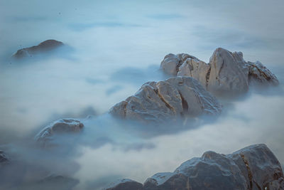 Scenic view of frozen sea and rocks