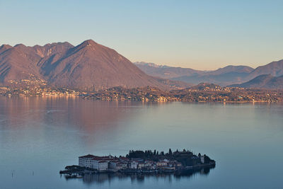 Scenic view of lake and mountains against clear sky